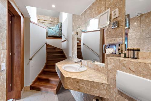 a bathroom with a sink and a staircase at Best Western Strand Hotel in Visby