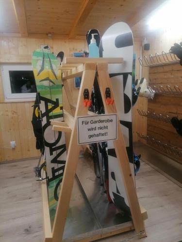 a stand with snowboards on it in a room at BergAufe Chalets Mallnitz in Mallnitz