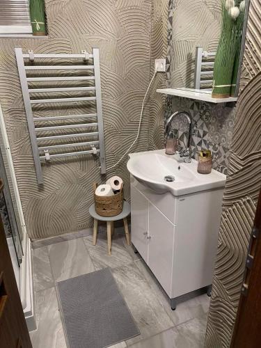 a small bathroom with a sink and a sink at Kertész Vendégház in Siófok