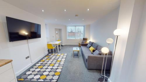 a living room with a couch and a table at Apartment 332 in Hull