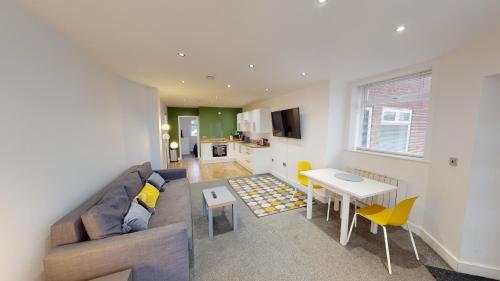 a living room with a couch and a table at Apartment 332 in Hull