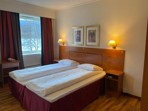 a bedroom with a large bed and a window at Park Hotel Vossevangen in Vossevangen