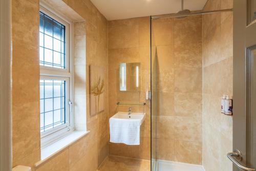 a bathroom with a sink and a shower at The Rising Sun in Backwell