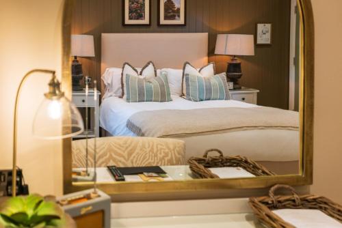 a bedroom with a bed with a large mirror at The Rising Sun in Backwell