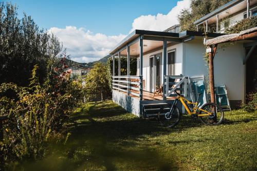 a yellow bike parked in front of a house at Agriturismo Rose di Pietra in Pietra Ligure