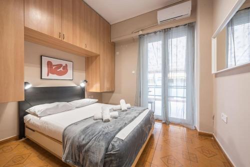 a bedroom with a large bed with white pillows at Pegasus Apartment in Piraeus