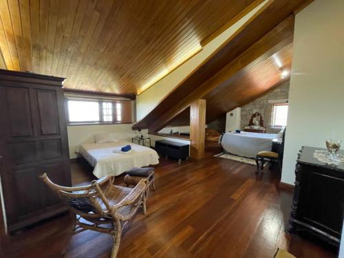 a large room with a bed and a bath tub at Casa do Alto (top floor apartment) in Adaúfe