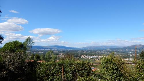 a view of a city from a hill with trees at Casa do Alto (top floor apartment) in Adaúfe