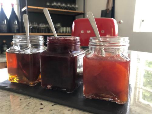 three jars of honey sitting on a counter at Tempel Wines in Paarl