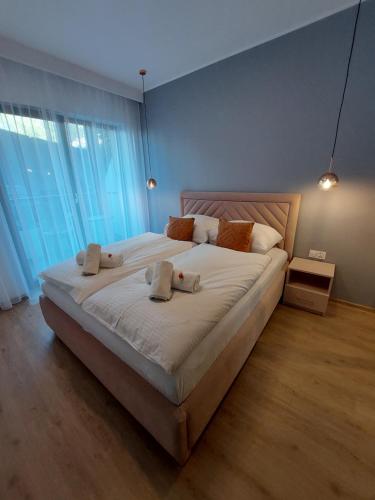 ein Schlafzimmer mit einem großen Bett mit zwei Kissen darauf in der Unterkunft Apartament Trójkąty i Kwadraty Karpatia Resort in Karpacz
