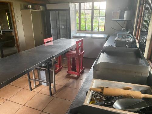 a kitchen with a large table in the middle at Vilagama Game Lodge in Naboomspruit