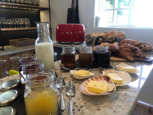 a kitchen counter with cheese and other food on it at Tempel Wines in Paarl