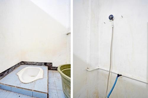 a bathroom with a toilet in the corner of a room at OYO Life 91947 Kost Barokah Syariah in Mojokerto