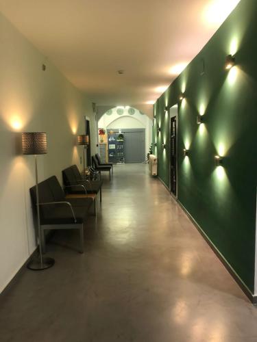a hallway with a green wall with lights on it at Albergue Inturjoven Cazorla in Cazorla