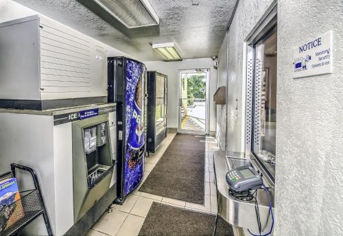a hallway of a kitchen with a phone in it at Motel 6 Colorado Springs, CO – South/Metro Area in Colorado Springs