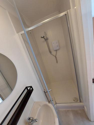 a bathroom with a shower with a toilet and a mirror at bankwellstreet in Manchester