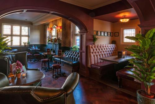 a restaurant with chairs and tables and a bar at The Rising Sun in Backwell