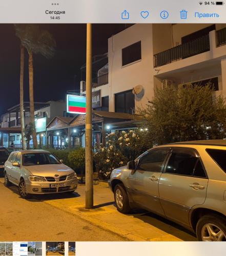 two cars parked on a city street at night at TaniAndres apartments in Paralimni