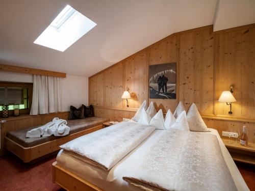 a bedroom with two beds and a skylight at Huaterhof in Zell am Ziller