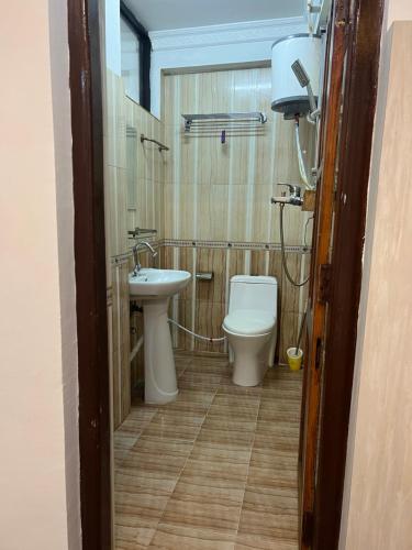 a bathroom with a toilet and a sink at Newa service apartment in Pātan