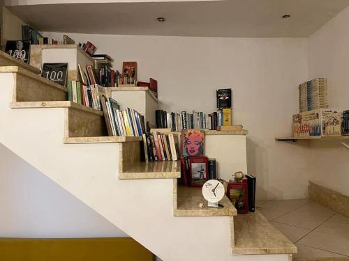 a room with shelves with books and a clock at Casa Al Vino sul Vesuvio in Pollena Trocchia