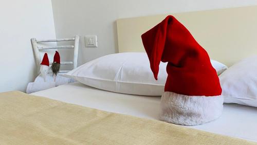 a red and white hat sitting on a bed at La Rocchetta, Borgo Valsugana in Borgo