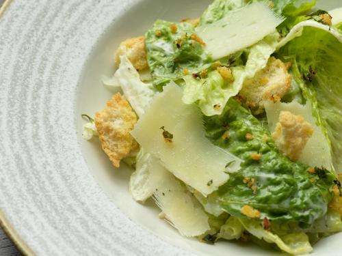 a white plate with a salad with lettuce and cheese at Holiday Inn Southampton Eastleigh by IHG in Southampton