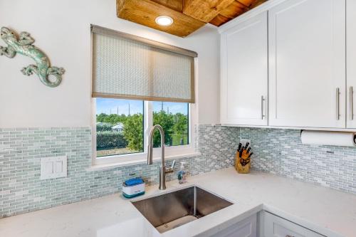 a kitchen with a sink and a window at Two White Turtles in Islamorada