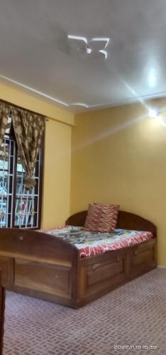 a bed in a room with a ceiling at Beth Meon Homestay in Darjeeling