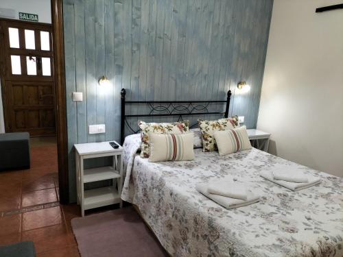 a bedroom with a bed with a white comforter at V.V Casa Mones in Cangas de Onís