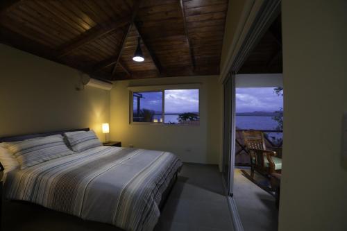a bedroom with a bed and a view of the ocean at Sava Salinas in Las Salinas