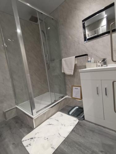 a bathroom with a shower and a sink at Luxurious 4 bed adorable house in Willington in Willington