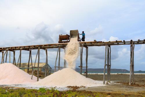 a man standing on top of a pile of sand at Sava Salinas in Las Salinas
