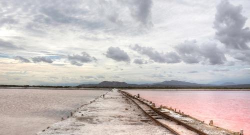 a dock in the middle of a body of water at Sava Salinas in Las Salinas
