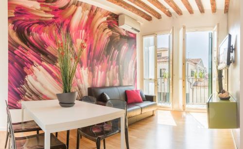 a living room with a wall mural of flowers at San Polo Design Apartments by Wonderful Italy in Venice