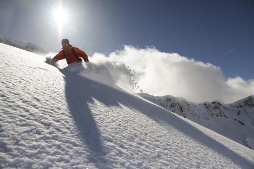 a person is skiing down a snow covered slope at Onpoint Madarao in Myoko