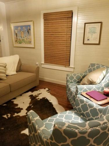 a living room with a couch and chairs and a window at Clemson Memorabilia House Frank Howard III Home in Clemson