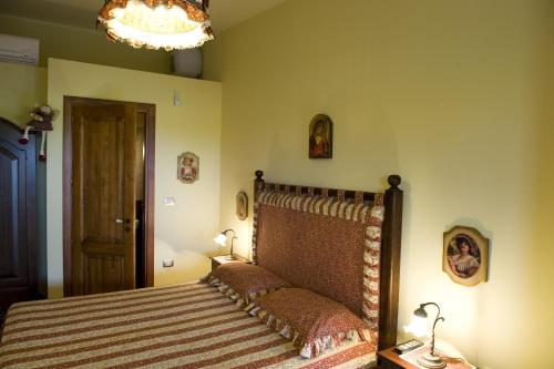 a bedroom with a bed and a chandelier at Le Querce di Mamre in Manfredonia