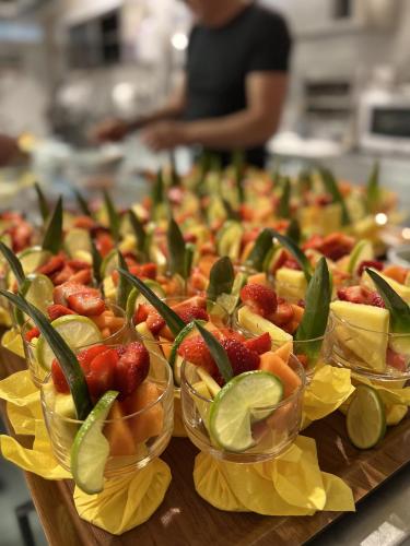 a buffet of fruit in plastic bowls on a table at Hotel Ai Pini in Grado