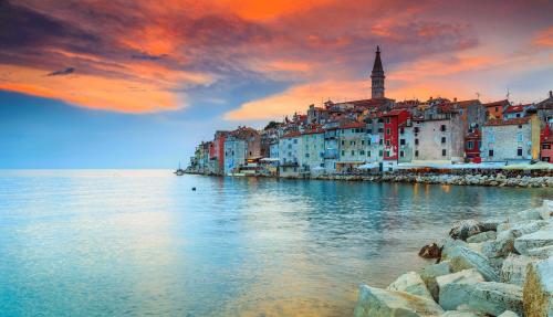 a group of buildings on the shore of the water at The Melegran in Rovinj