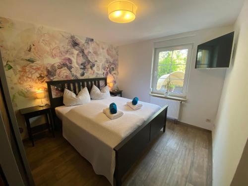 a bedroom with a bed with two vases on it at Seeblick Apartments Mühlau in Mühlau