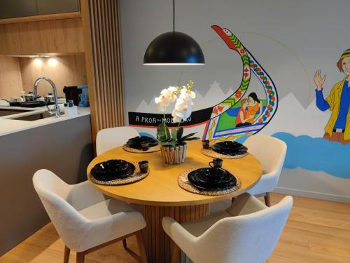 a dining room table with white chairs and a dining room at A Proa do Moliceiro - KING BED with Wall Mirror in Aveiro