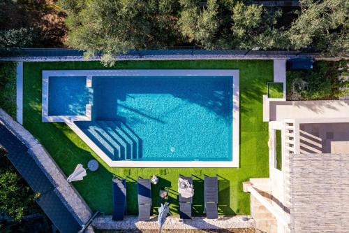 an overhead view of a swimming pool on a lawn at Villa Moreta with heated pool, Sauna, Hot-tub in Trogir