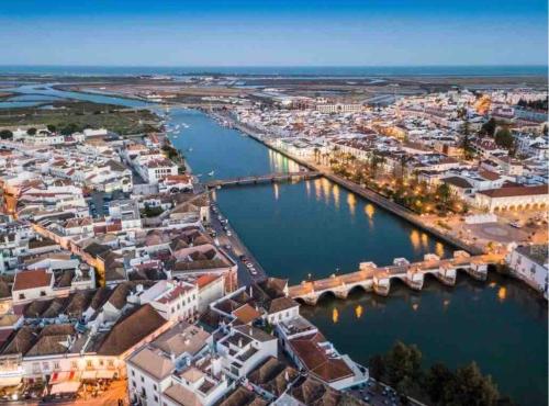 an aerial view of a city with a river at The Doll’s House in Tavira