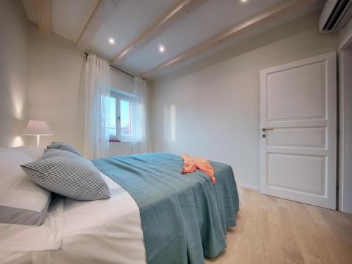 a bedroom with a bed with a blue blanket on it at Villa Zdenka in Vis