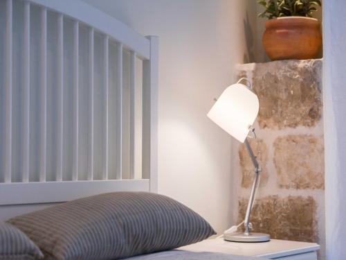 a bedroom with a bed and a lamp on a table at Villa Zdenka in Vis