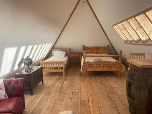 Zimmer im Dachgeschoss mit 2 Betten und einem Sofa in der Unterkunft Shortlake Cottage in Osmington