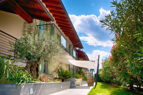 a building with a umbrella in front of it at Residence Verdeblu in Arco