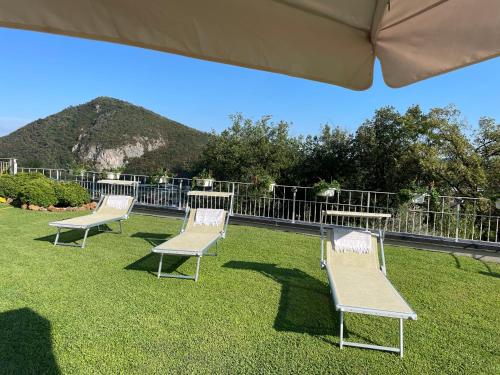 a group of chairs sitting on top of a lawn at CHALET VELA Natura e Relax in Gavardo