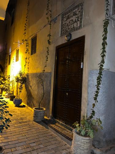 a door to a building with potted plants in front at Riad Dar Skalli & SPA in Fès
